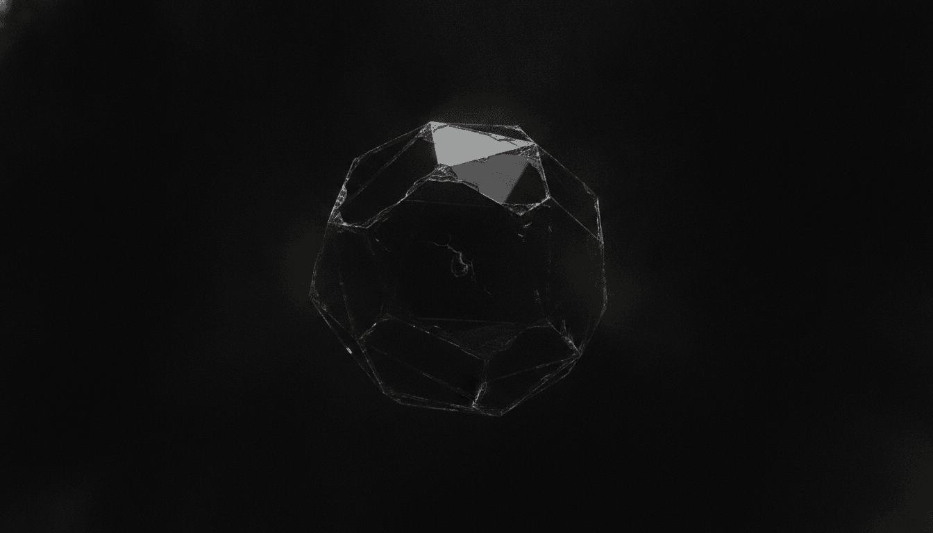 Faceted obsidian still coalescing, one faint ember at the center
